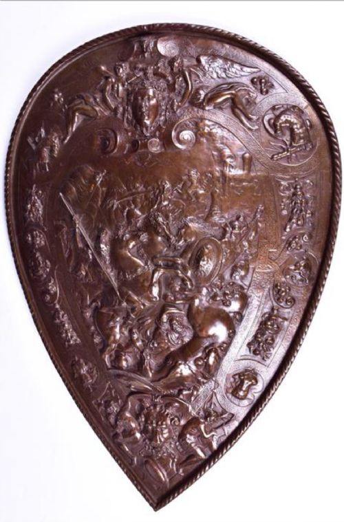 a bronzed cast iron wall hanging shield
