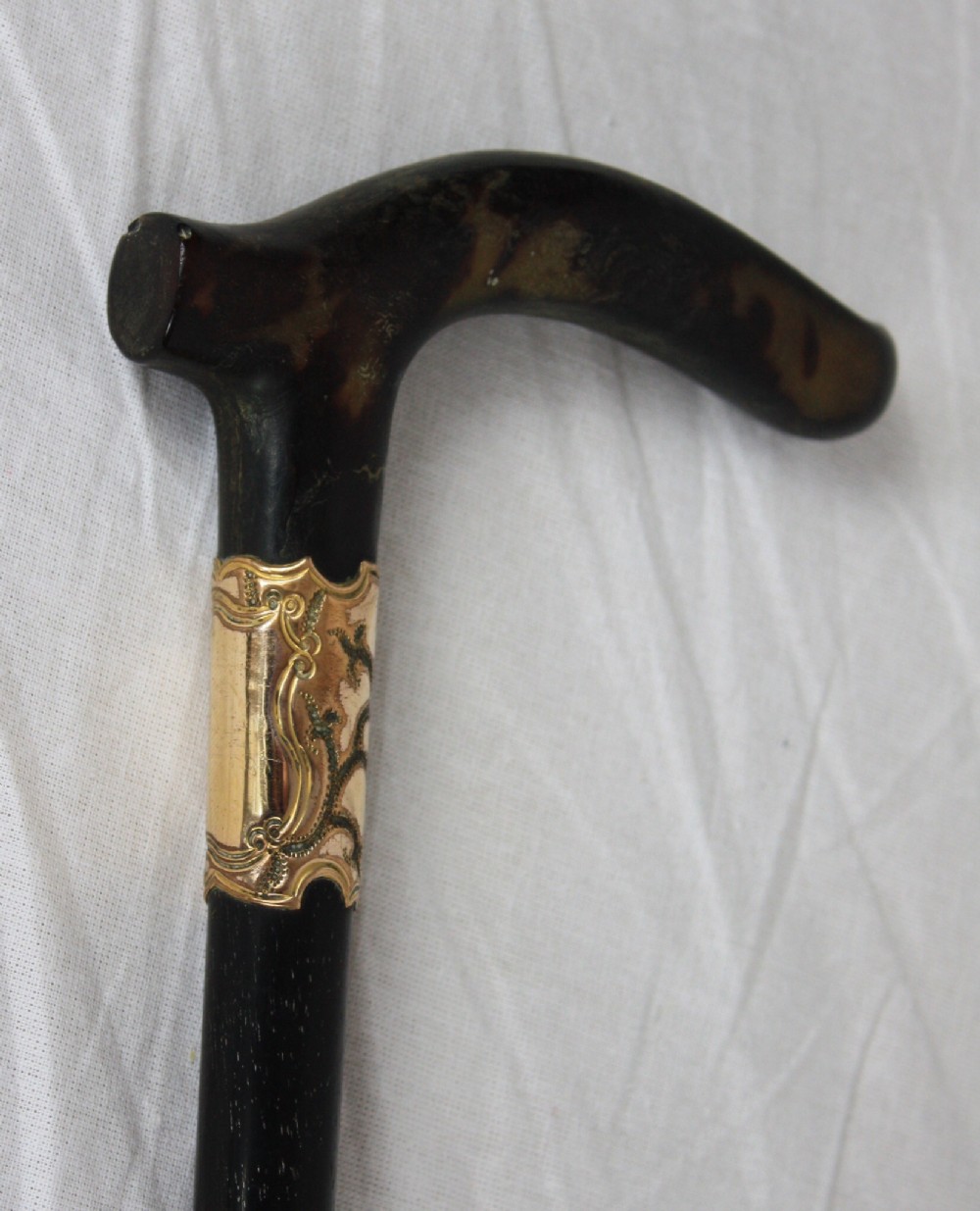 tortoishell and gold collared walking stick