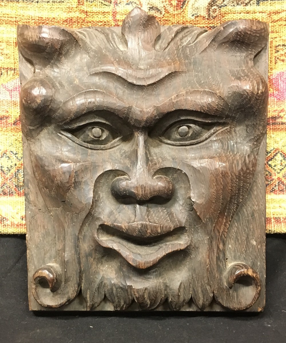 c18th oak carving of satyrs face