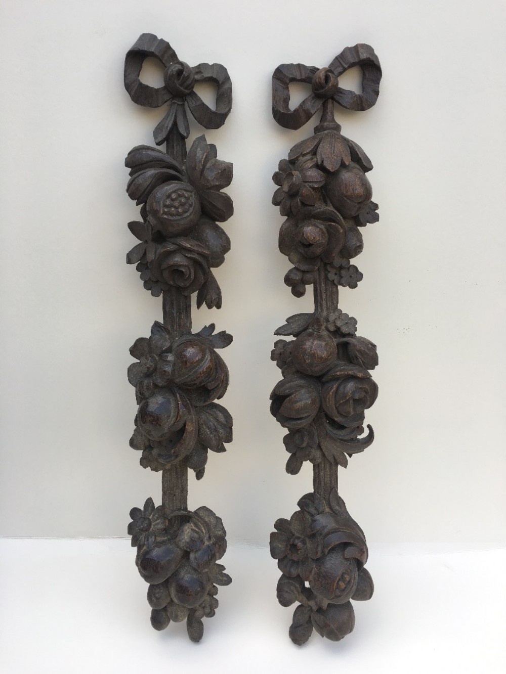 pair of carved oak wall hangings
