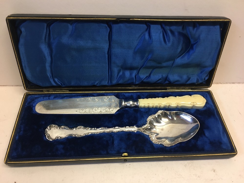 pair of silver plated servers in a fitted case