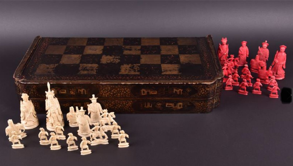 a c19th chinese lacquered chessboard box with ivory chess pieces