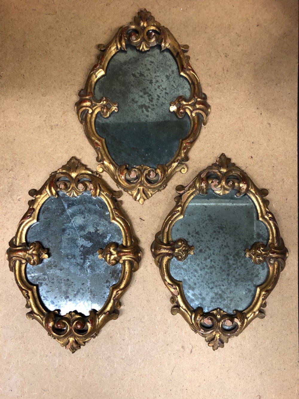 three small carved giltwood mirrors