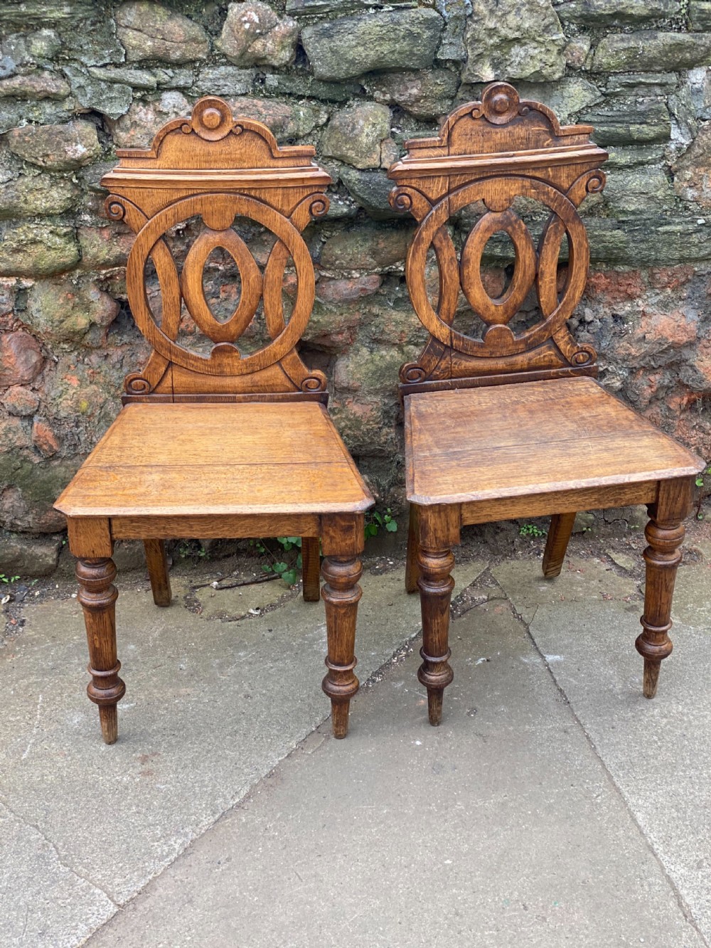 pair of oak hall chairs with fretwork backs