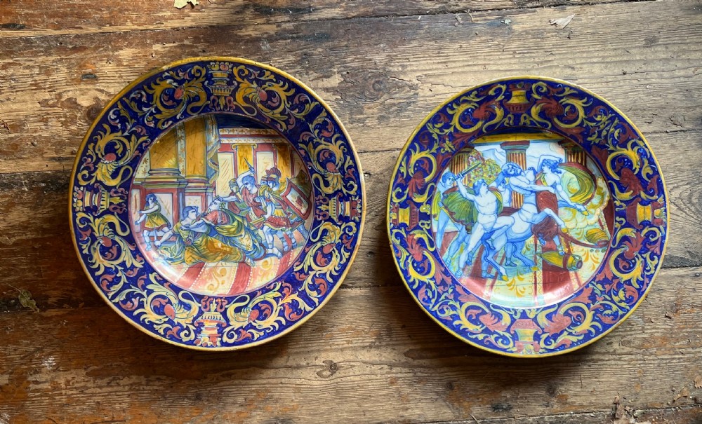 pair of maiolica chargers depicting classical scenes