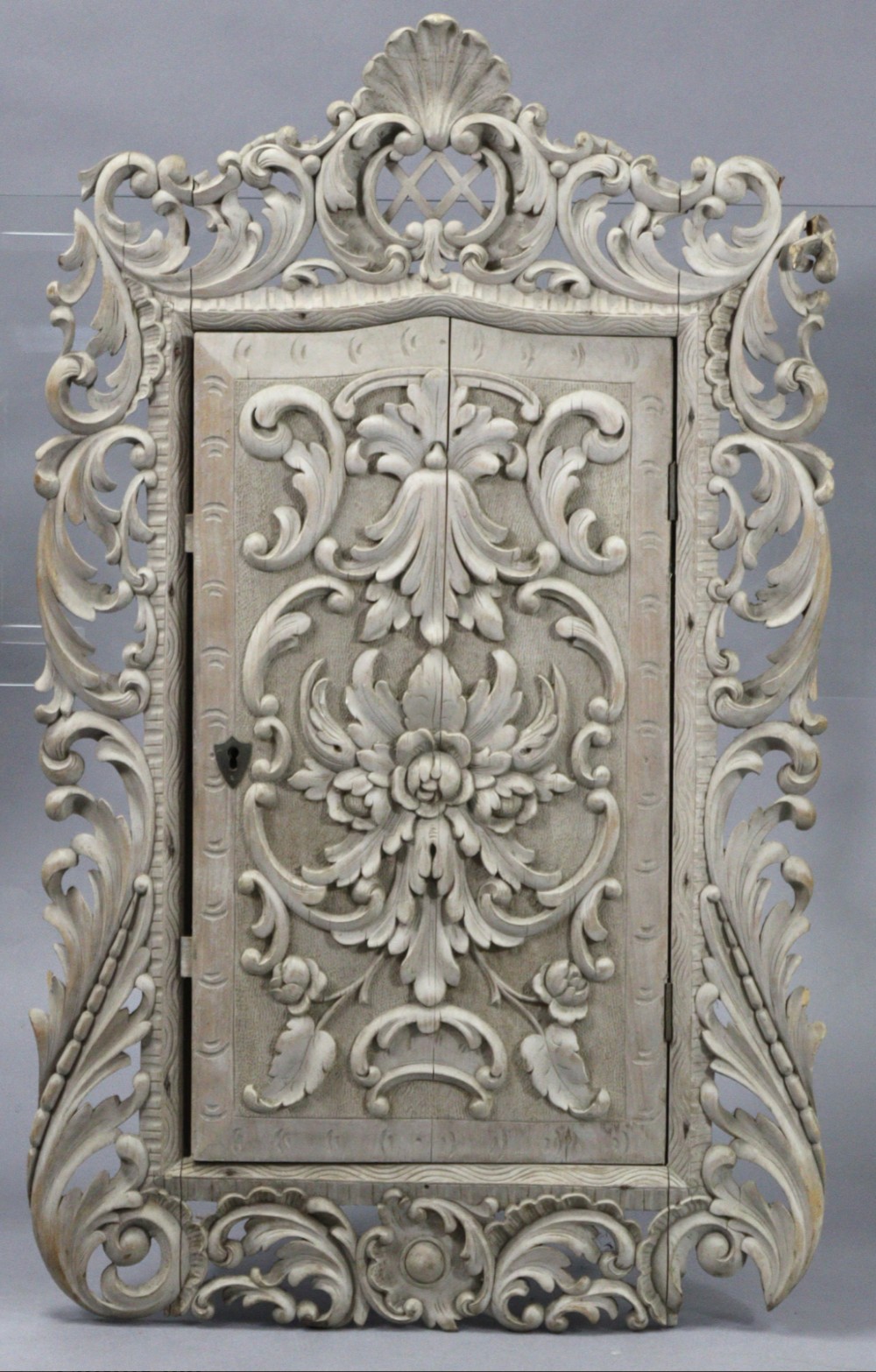 a carved wood mural cupboard