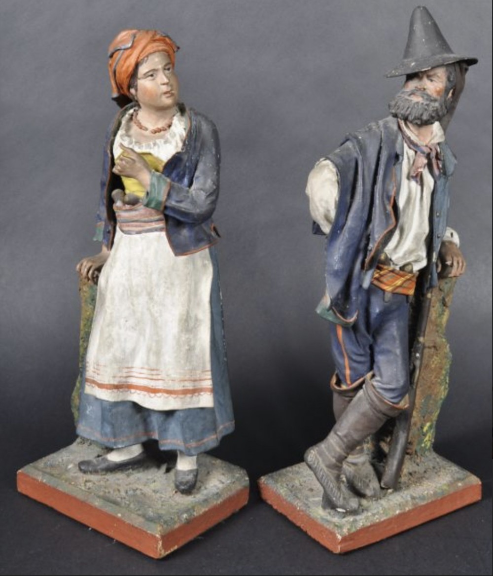 pair of neopolitan painted cork and papiermch figures
