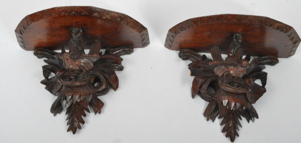 pair of c19th black forest carved wall brackets depicting birds in foliage