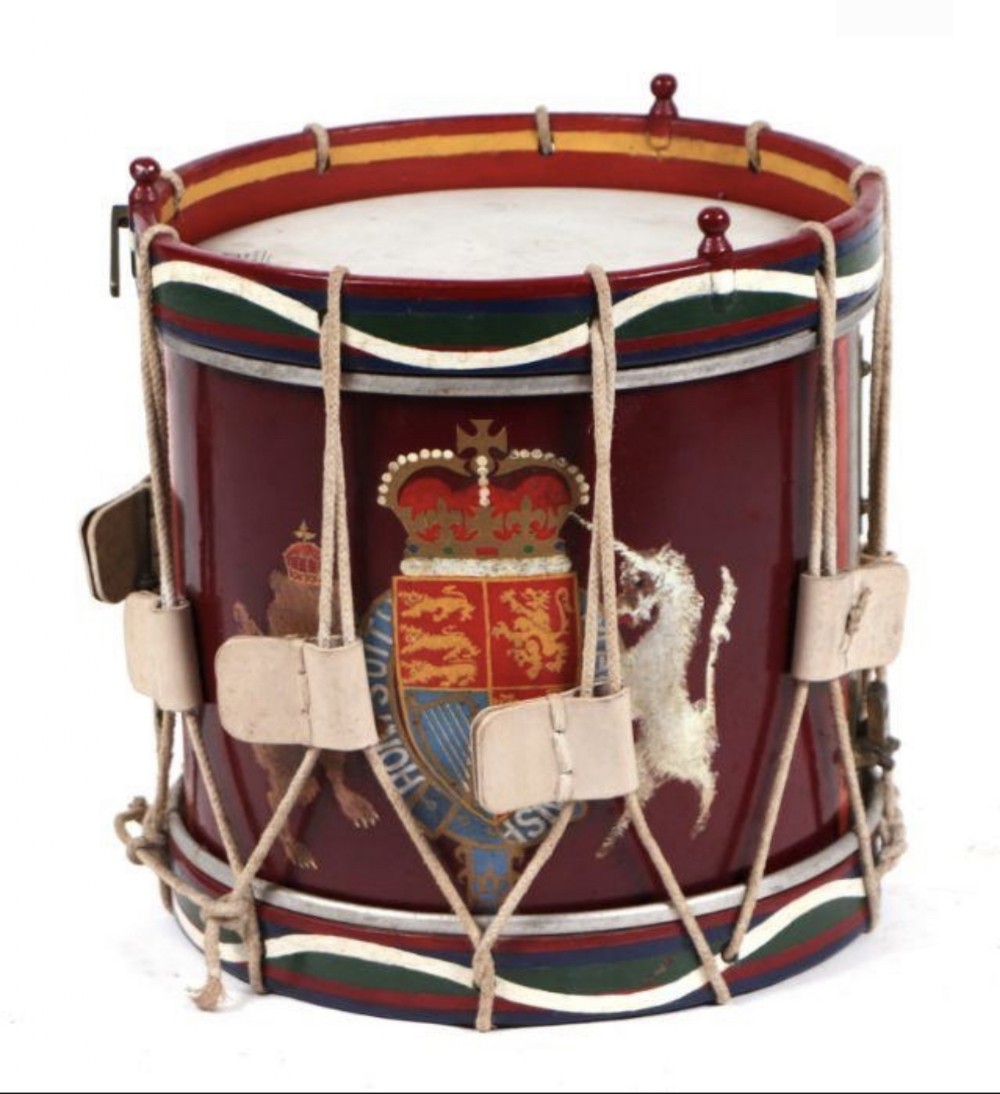 a military marching band drum decorated with the royal coat of arms