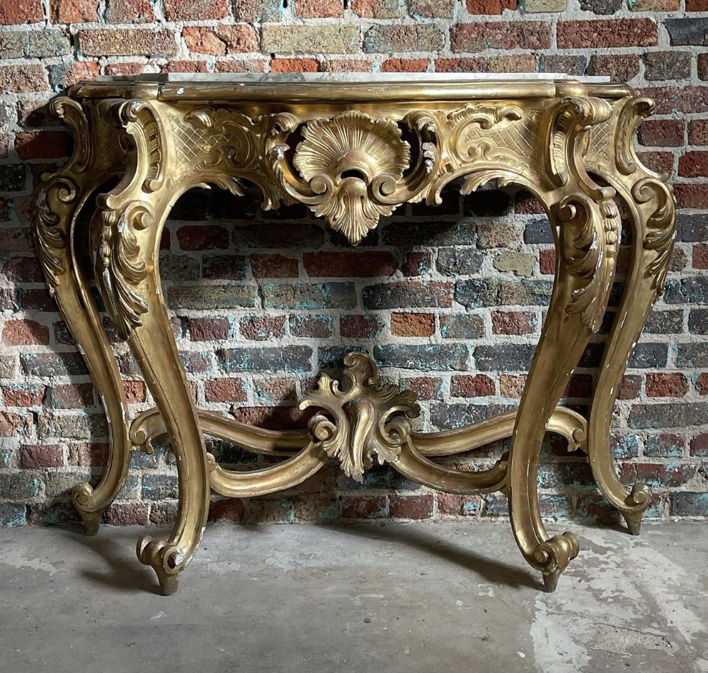 c18th carved and gilded console table with marble top in the rococo manner