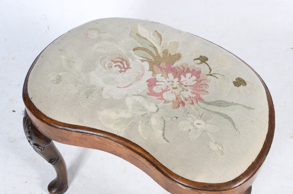 walnut kidney shaped stool with embroidered seat