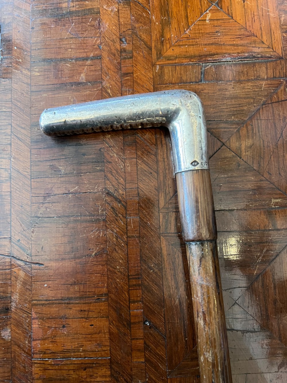 silver handled walking stick with palm wood shaft