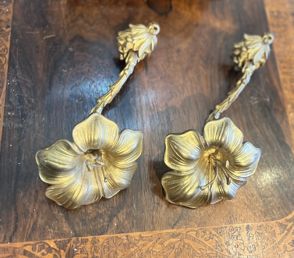 pair of giltbrass curtain tie backs withstylised flower head