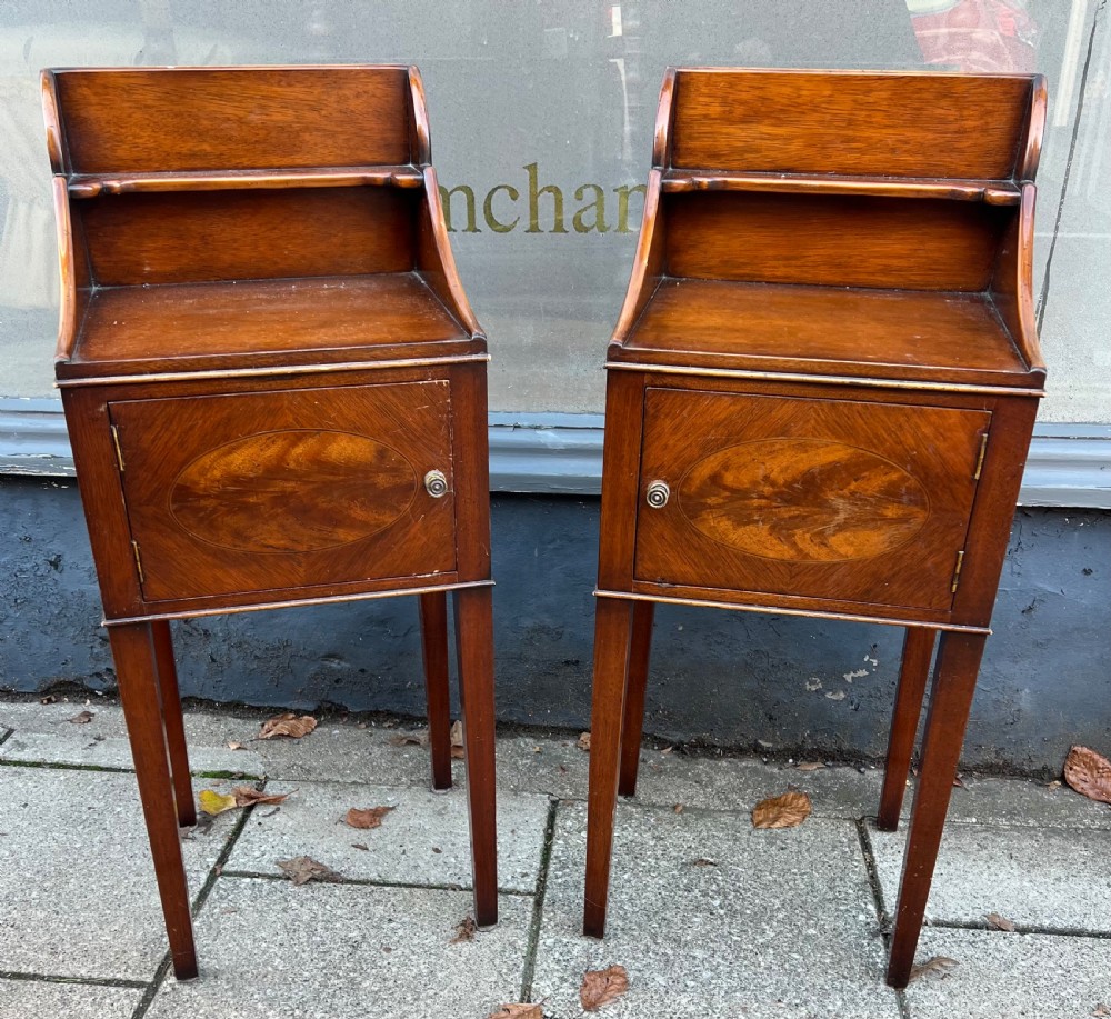 a pair of mahogany bedside cupboards